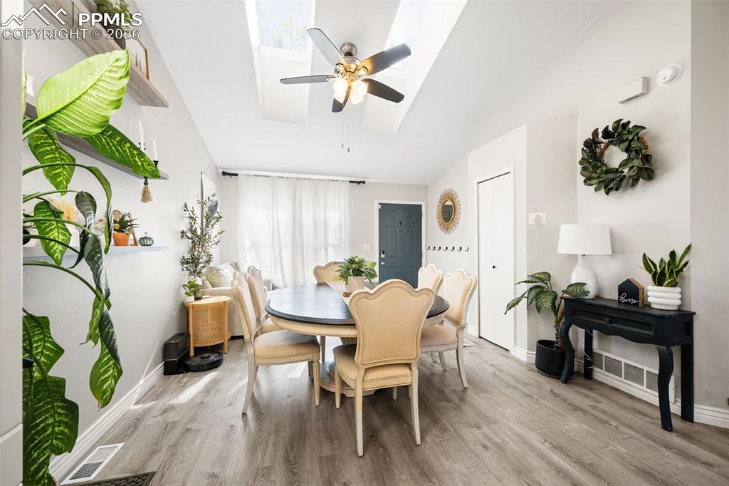 Image 17 of 50: The dining area features light wood-style flooring and a light-colored ceil
