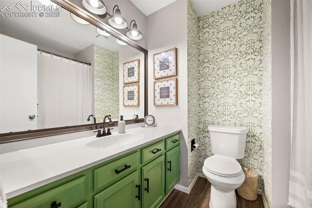 Image 29 of 50: Bathroom featuring a white vanity top, a rectangular sink with a dark-toned