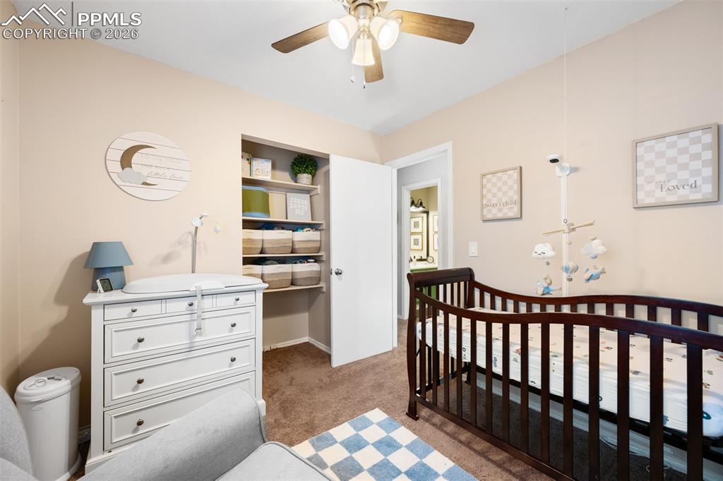 Image 31 of 50: This room features light-colored walls and carpeted flooring, with a ceilin