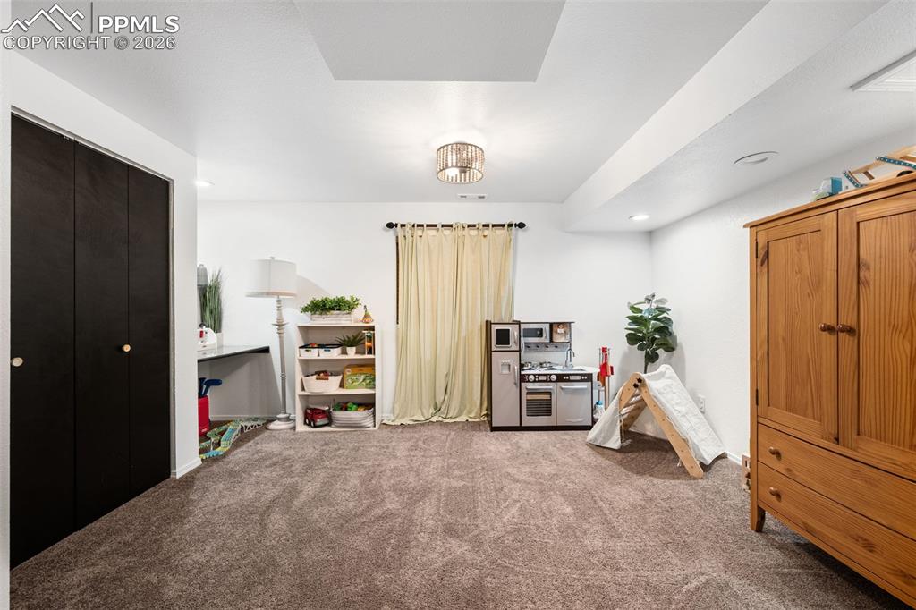 Image 33 of 50: The property features an interior room with carpeted flooring, white walls,