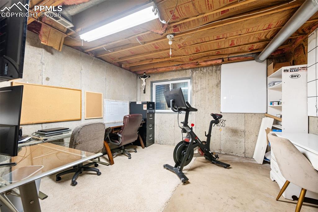 Image 36 of 50: This versatile space features concrete walls, exposed ceiling joists with i