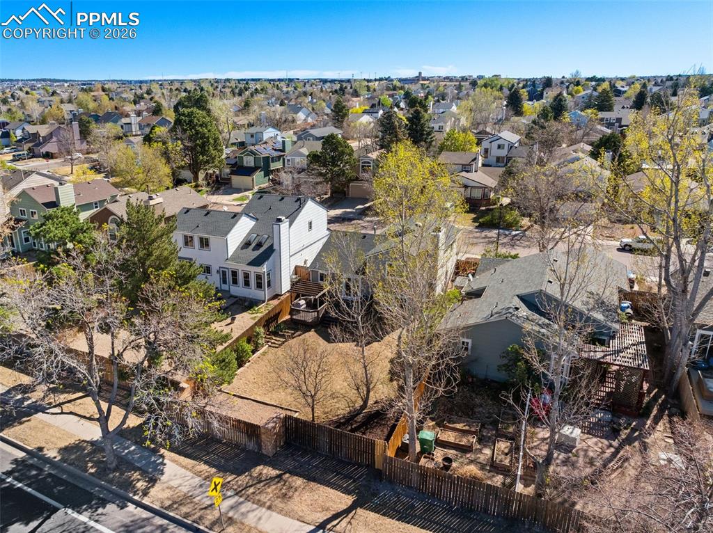 Image 45 of 50: The property features a white exterior with a dark roof and a chimney