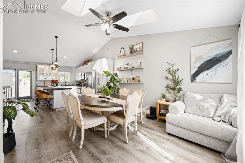 Image 5 of 50: The open-concept living area features vaulted ceilings with skylights and a