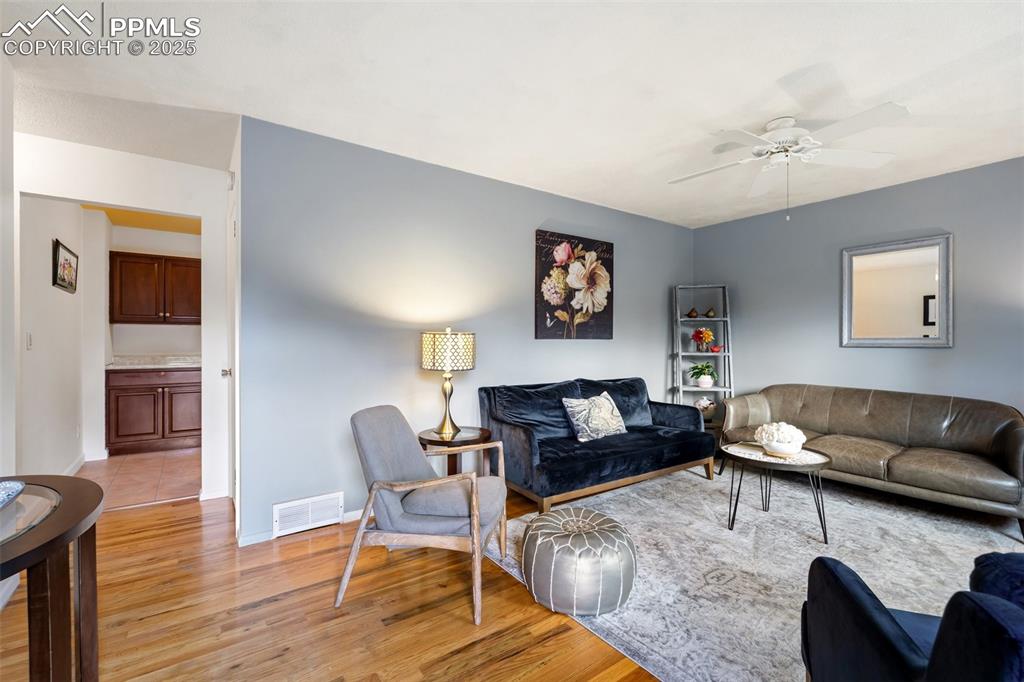 Image 8 of 45: Freshly painted interior with gorgeous hardwood floors throughout main leve