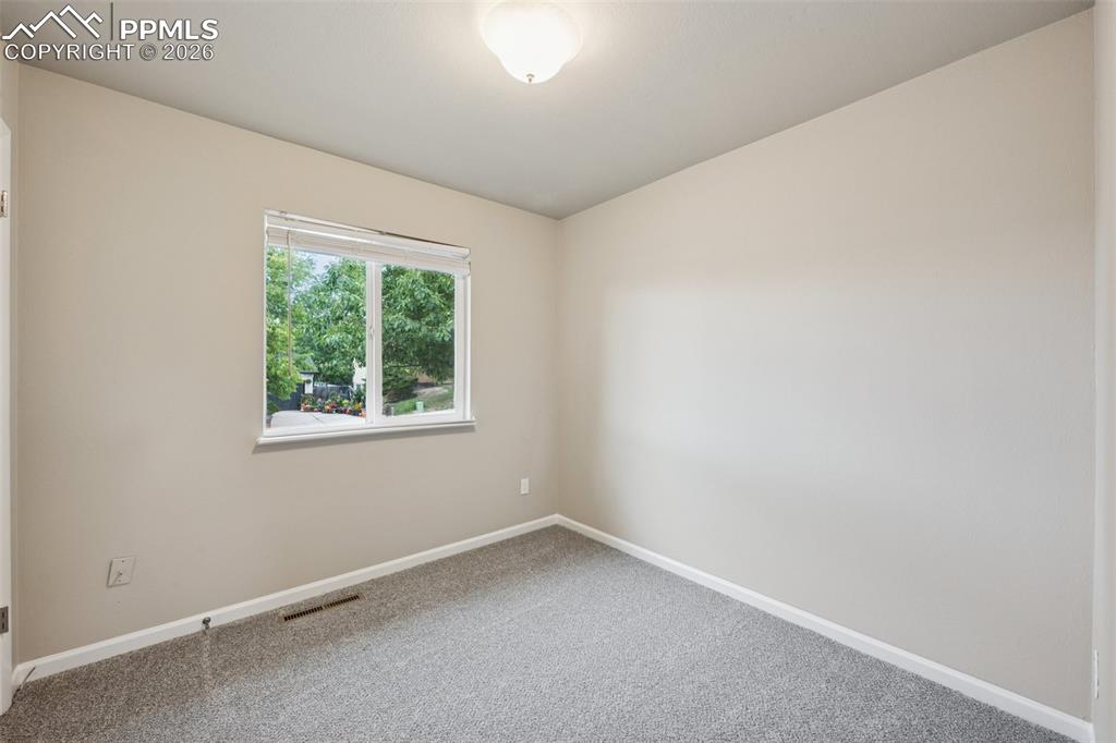 Image 12 of 34: Carpeted spare room with baseboards
