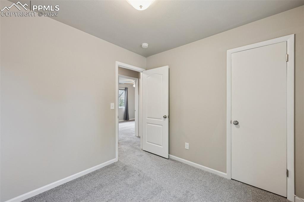 Image 13 of 34: Unfurnished bedroom featuring baseboards and carpet floors