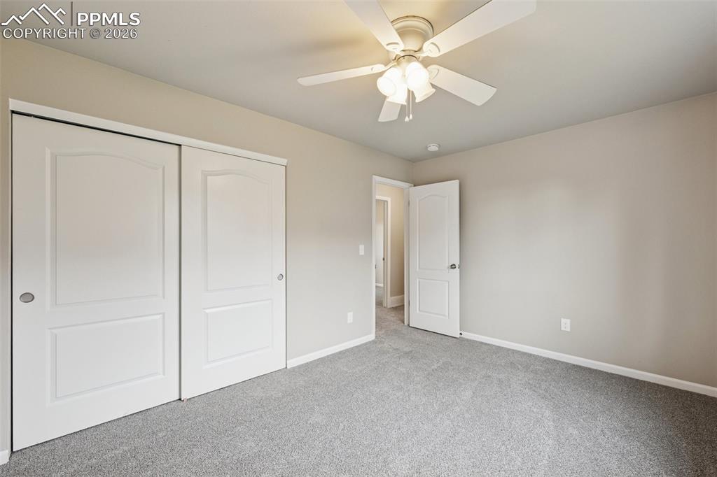 Image 15 of 34: Unfurnished bedroom with carpet floors, a closet, and a ceiling fan
