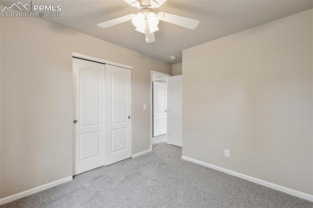 Image 17 of 34: Unfurnished bedroom featuring carpet flooring, a closet, and ceiling fan