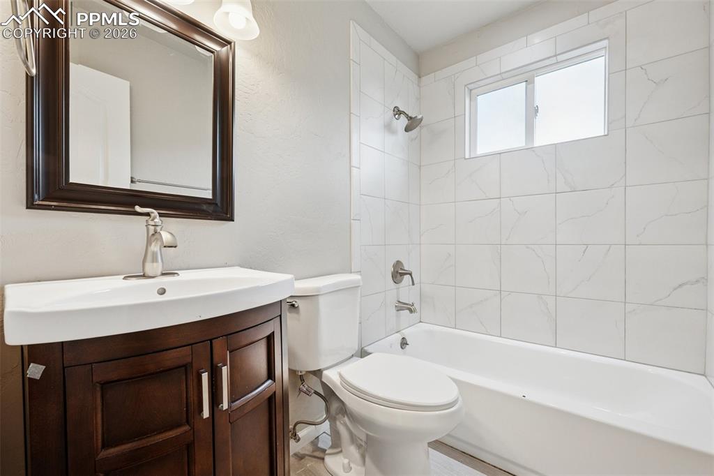 Image 18 of 34: Full bathroom with vanity and tub / shower combination