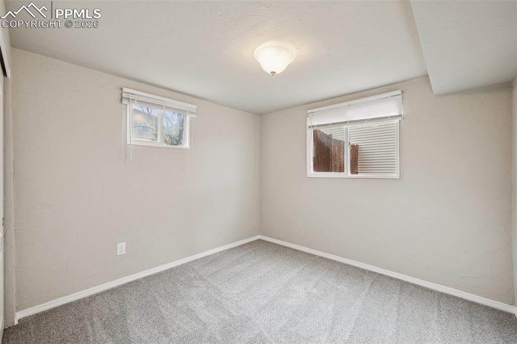 Image 26 of 34: Carpeted spare room with baseboards