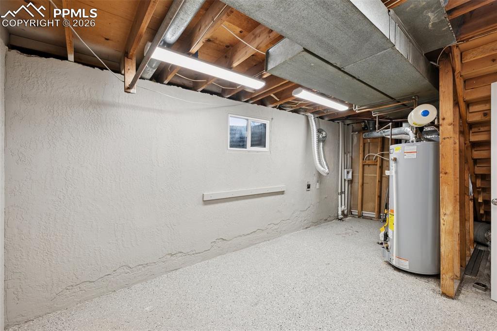 Image 28 of 34: Basement with water heater