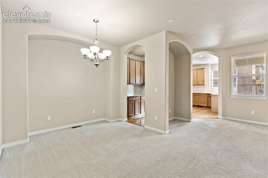 Image 17 of 44: Archway entryways to adjacent spaces, recessed wall feature, and a suspende