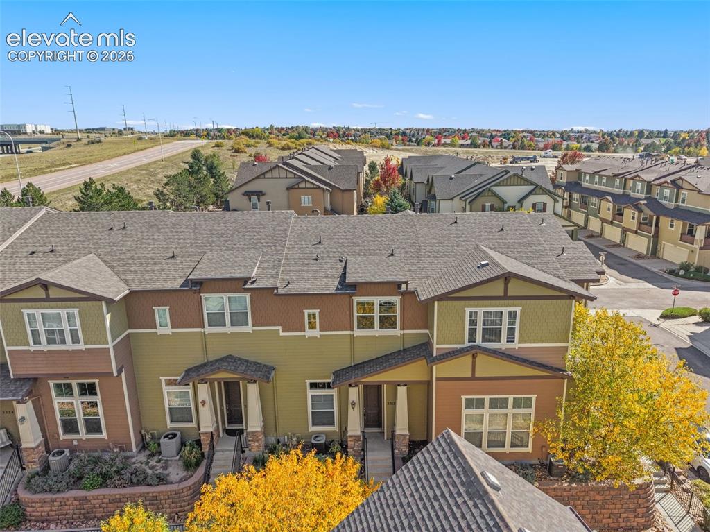 Image 2 of 44: Multi-level townhome featuring a neutral-toned exterior, gabled roofline, a