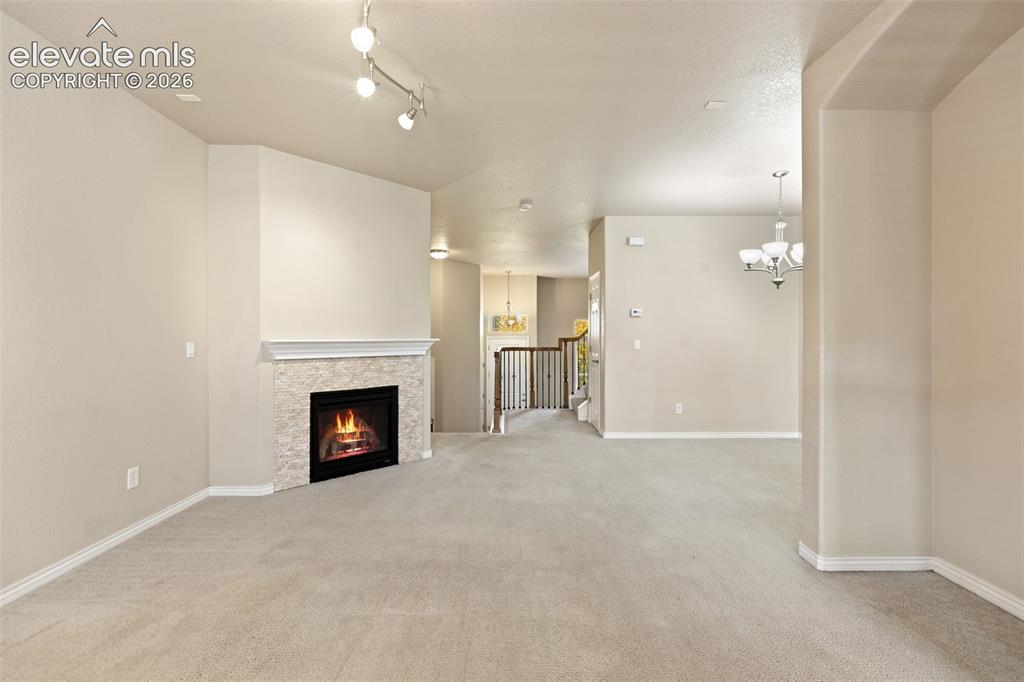 Image 21 of 44: Spacious open-concept living area featuring neutral wood-finish flooring th