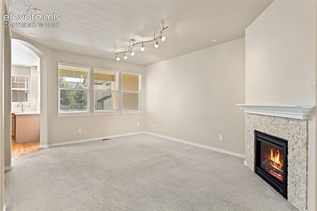 Image 22 of 44: Spacious living room with neutral carpet flooring, recessed lighting, and l