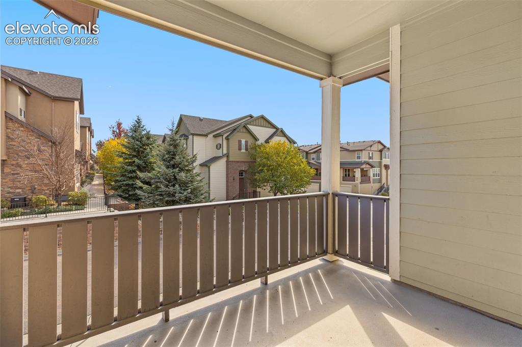 Image 29 of 44: Covered outdoor balcony featuring a painted concrete floor and a durable sl