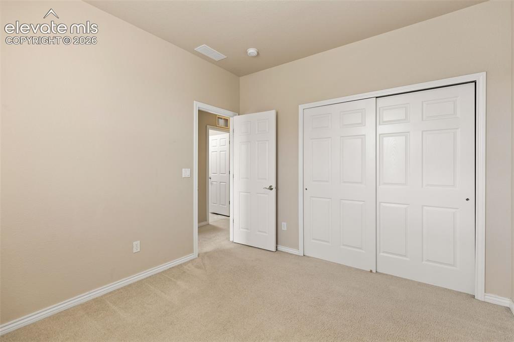 Image 39 of 44: Neutral-toned walls, cream carpeting, and white trim