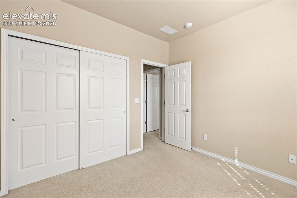 Image 42 of 44: Neutral paint tones, plush carpeting, white trim, and panel doors