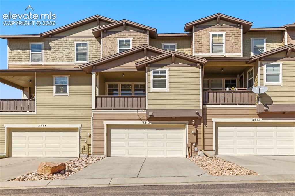 Image 9 of 44: Multi-level townhome exterior featuring horizontal siding and shingle accen
