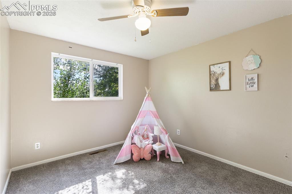 Image 13 of 29: Bedroom with carpet floors and ceiling fan