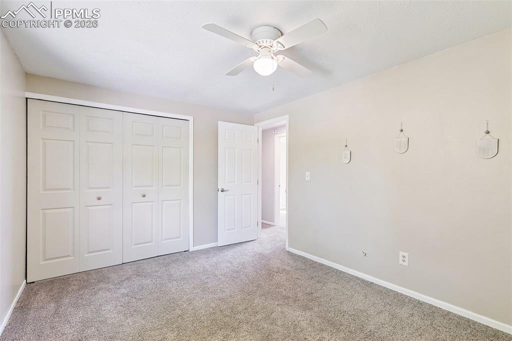 Image 17 of 29: Unfurnished bedroom featuring a closet, carpet floors, and a ceiling fan