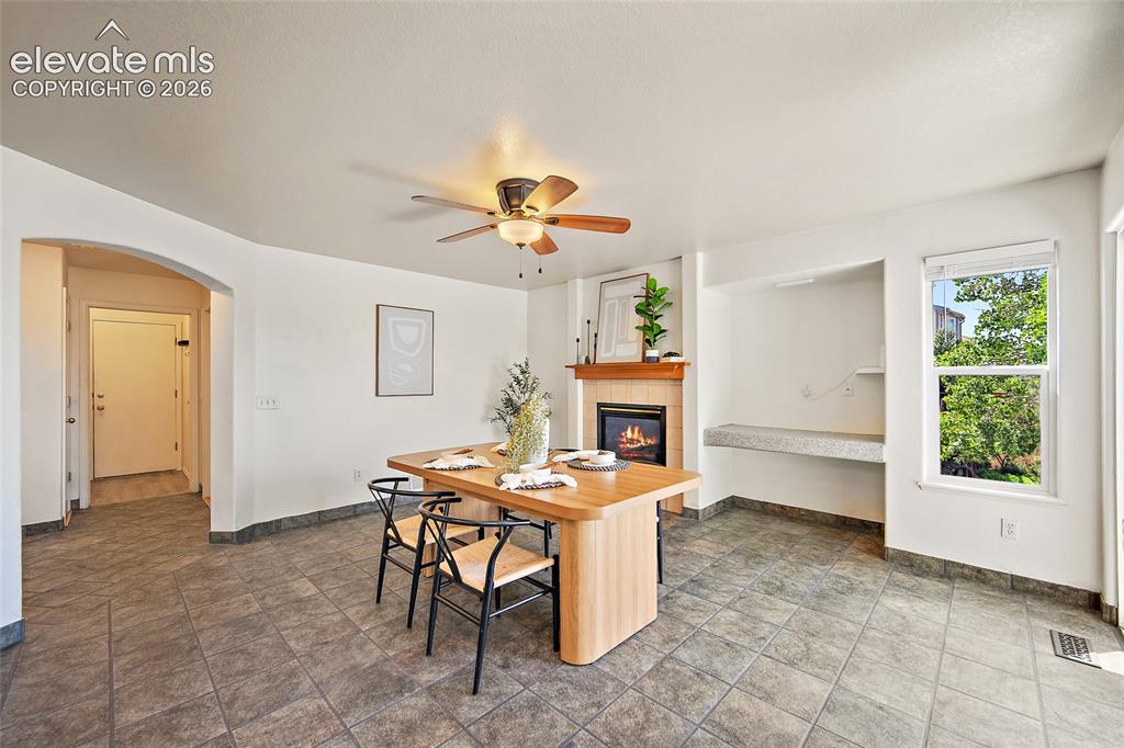 Image 11 of 45: Spacious room featuring tile flooring, a built-in fireplace with a wood man