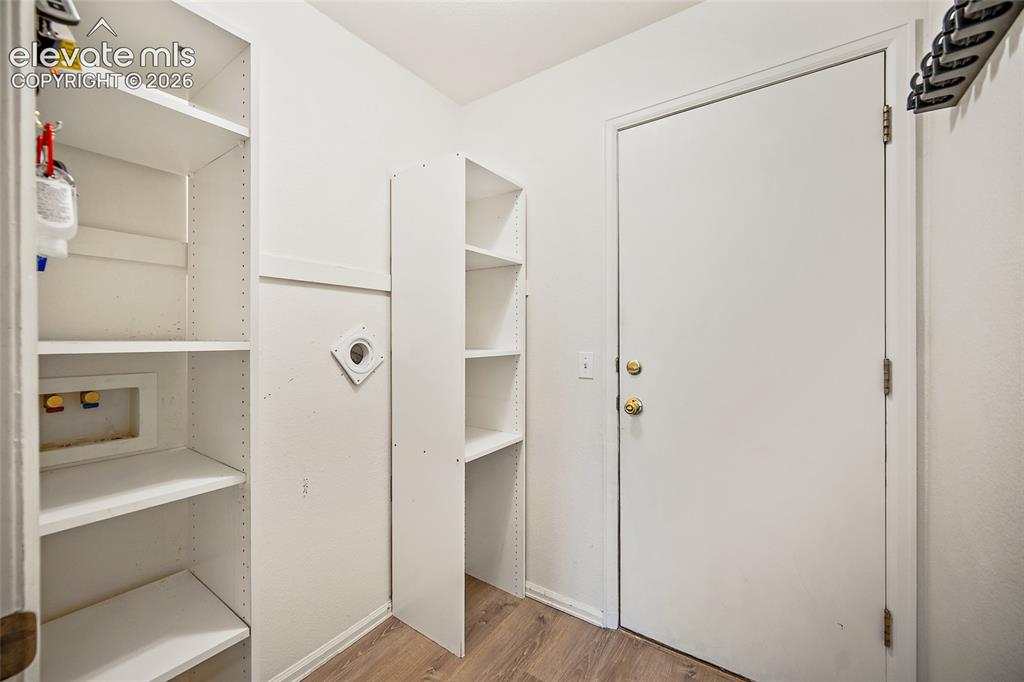Image 19 of 45: Laundry area with entry to garage
