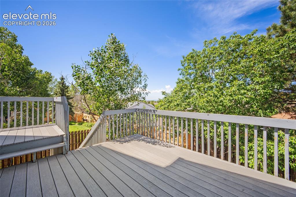 Image 4 of 45: Spacious composite deck with sturdy railings, integrated steps, and surroun