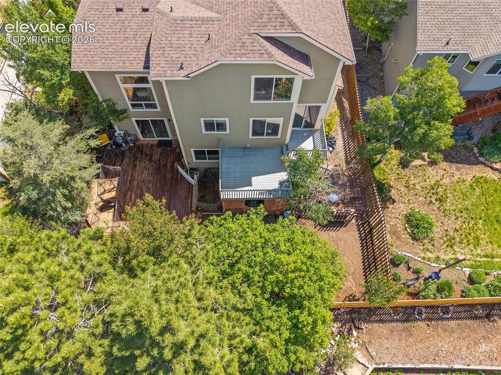 Image 40 of 45: Split-level property featuring a multi-tier wood deck, a partial privacy fe