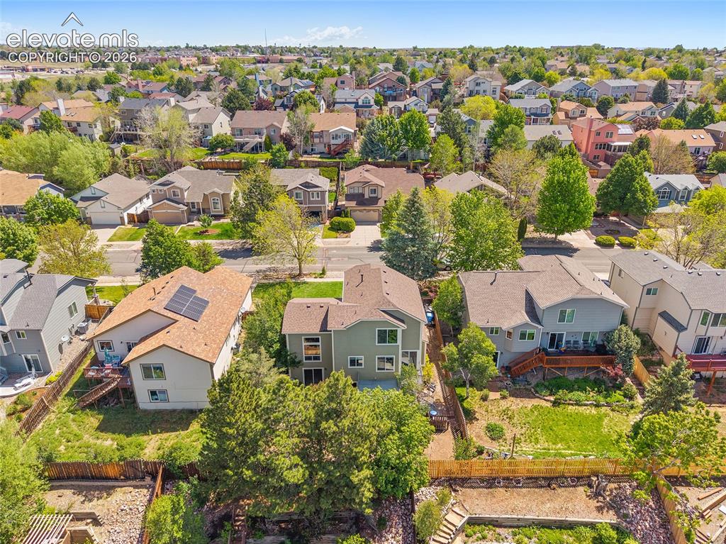 Image 41 of 45: Residential property featuring a rear deck with direct yard access, mature 