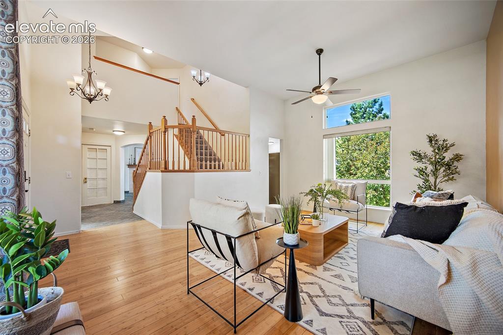 Image 6 of 45: Vaulted ceilings enhance this spacious living area, featuring wood-finish f
