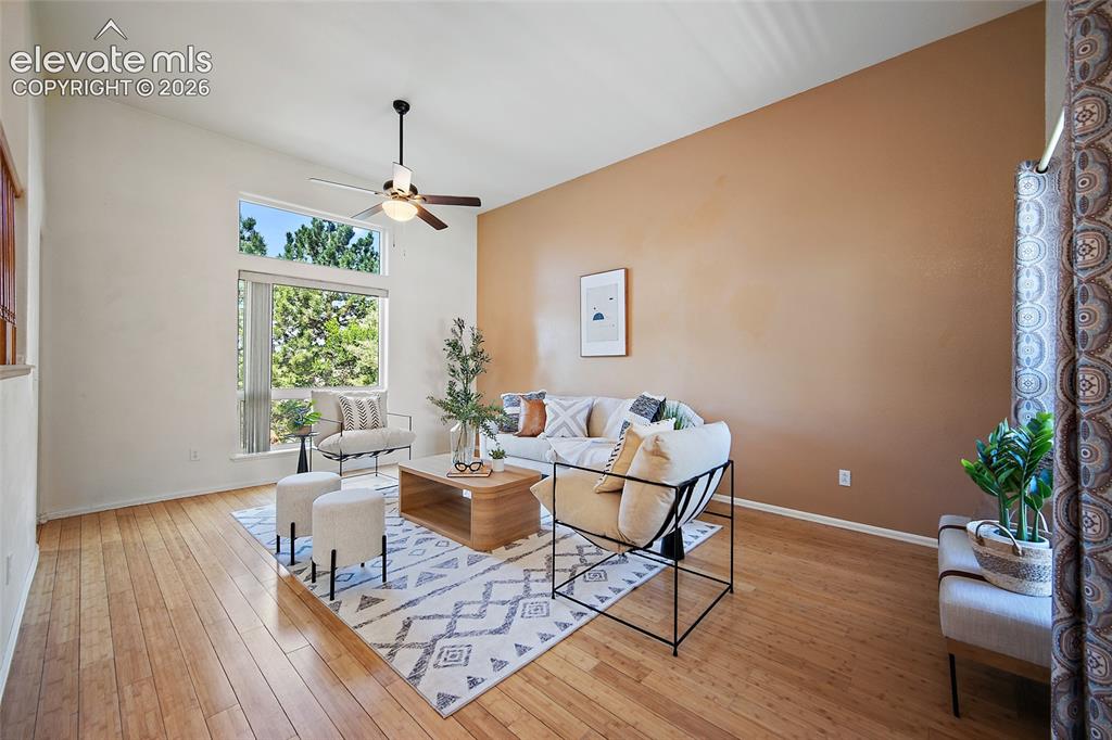 Image 7 of 45: Living area featuring vaulted ceilings, wood-finish flooring, a contemporar