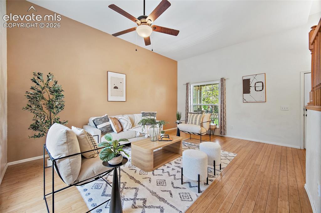 Image 8 of 45: Living area featuring wood-finish flooring, a vaulted ceiling, and a ceilin