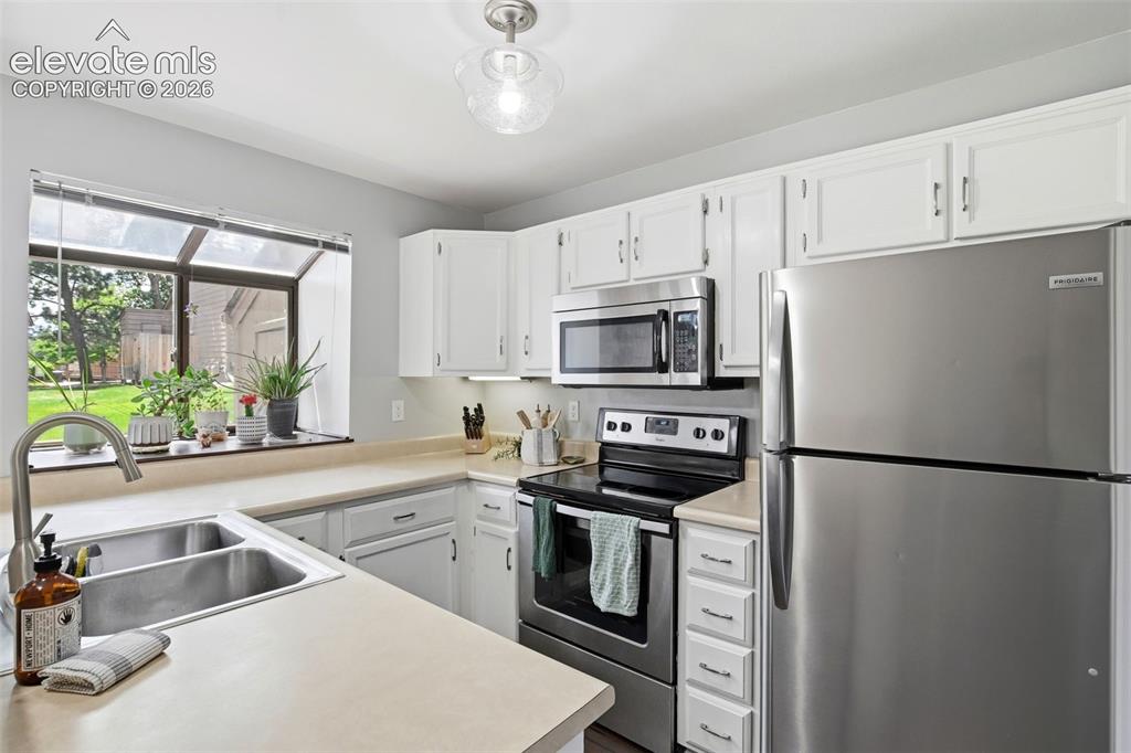 Image 12 of 49: Enjoy the natural light and stainless steel appliances throughout the kitch