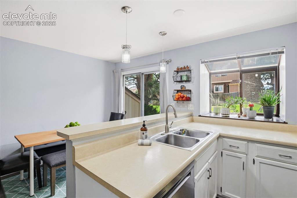 Image 13 of 49: Kitchen and dining area, with views of the back yard.