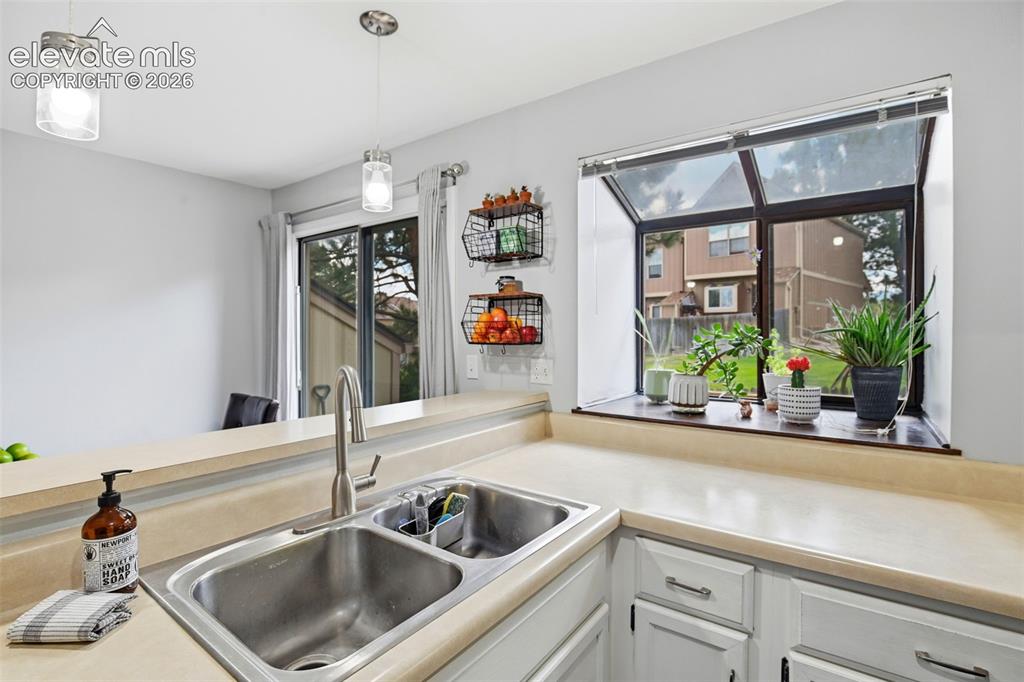 Image 15 of 49: Enjoy the extended kitchen window, perfect for an indoor herb garden!