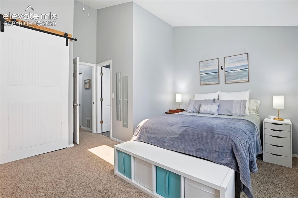 Image 20 of 49: The primary bedroom closet is accented with a beautiful barn door.