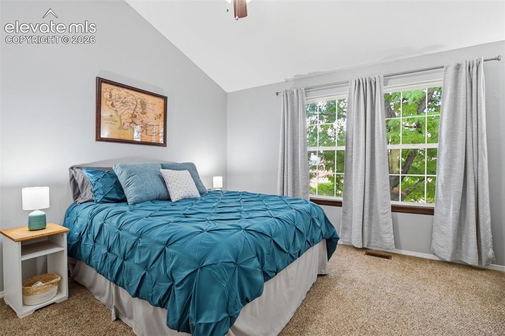 Image 25 of 49: A second bedroom upstairs also has abundant space and natural light.