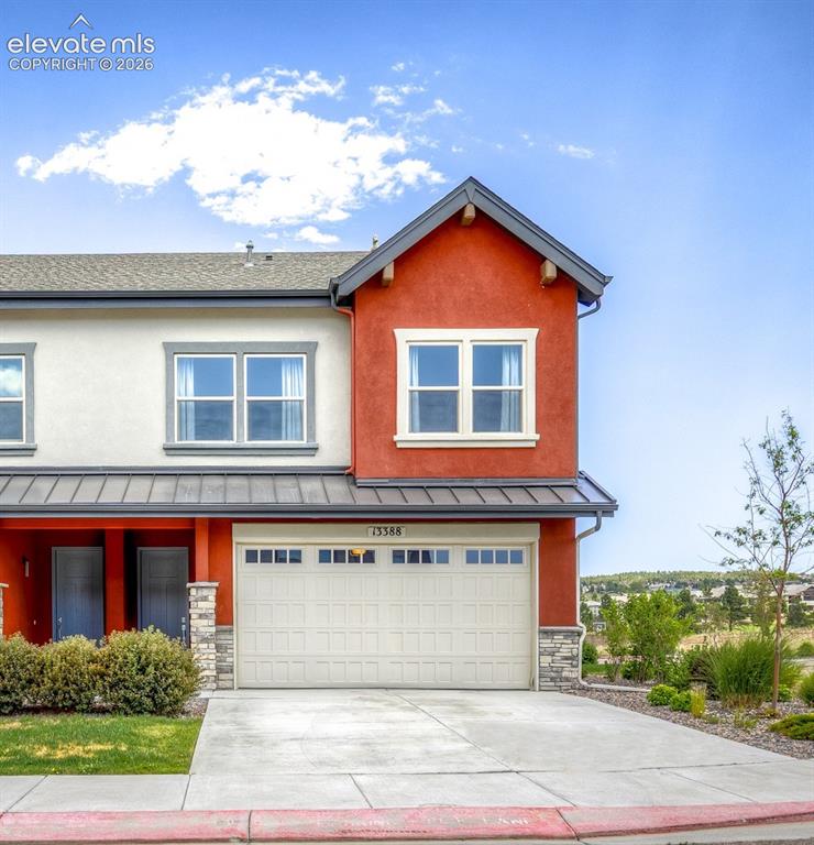Image 1 of 50: Multilevel stucco exterior with a two-car garage