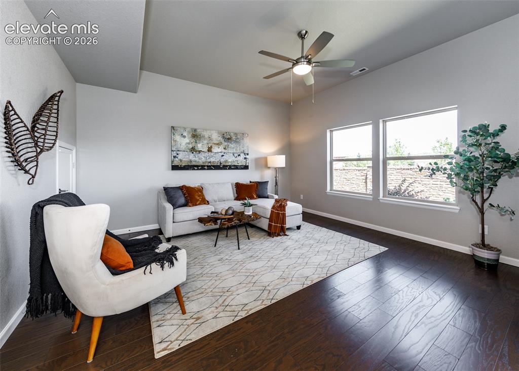 Image 23 of 50: Spacious interior featuring high vaulted ceilings, expansive windows, dark 
