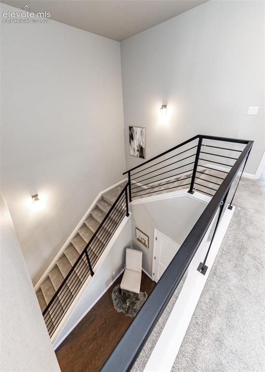 Image 25 of 50: Staircase featuring contemporary black metal horizontal railings and neutra
