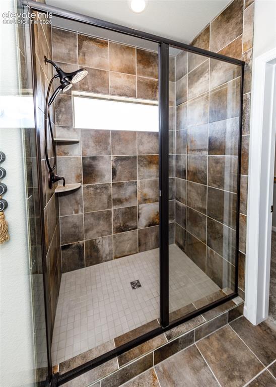 Image 35 of 50: Enclosed shower with clear glass and dark bronze framing