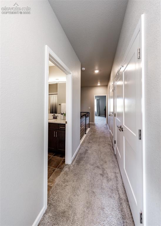 Image 37 of 50: Hallway featuring light gray carpeting, recessed ceiling lighting, and mult