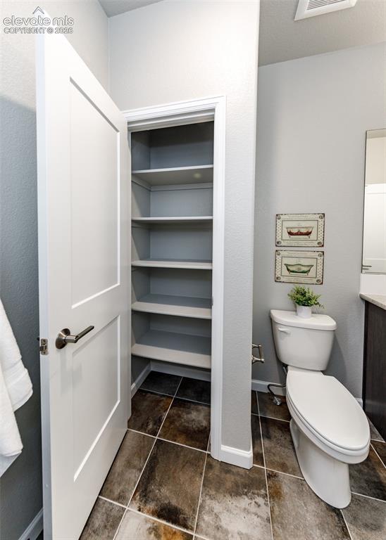 Image 42 of 50: Conveniently located built-in shelving unit with multiple shelves, a two-pi