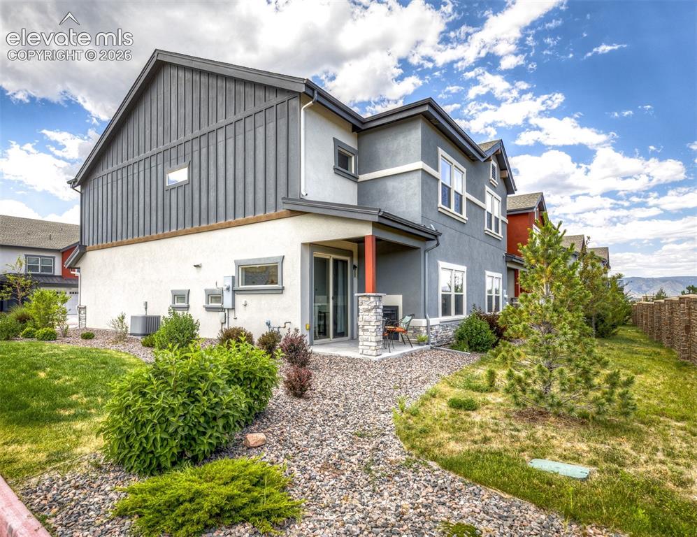 Image 48 of 50: Multi-story exterior featuring a mix of stucco and vertical siding