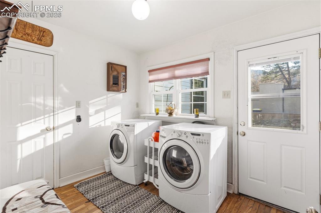 Image 25 of 50: Main level laundry room with a door that provides access to the outdoors!