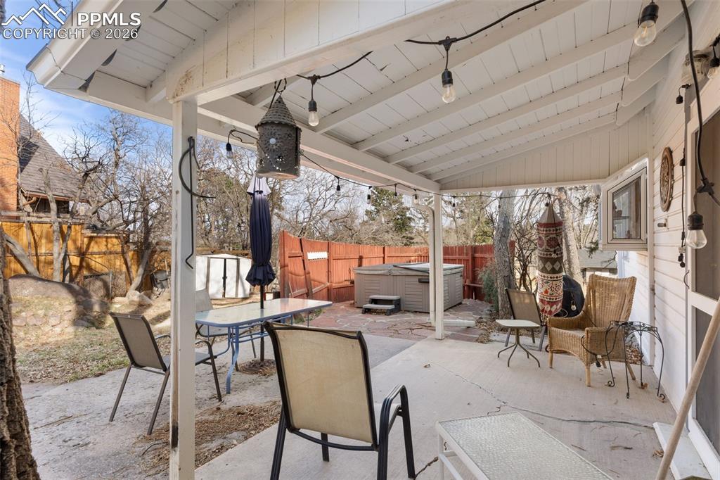 Image 29 of 50: Covered backyard patio of the main house to enjoy the great outdoors!