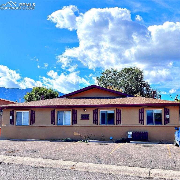 Image 1 of 17: Ranch-style four plex featuring stucco siding, uncovered parking, roof with