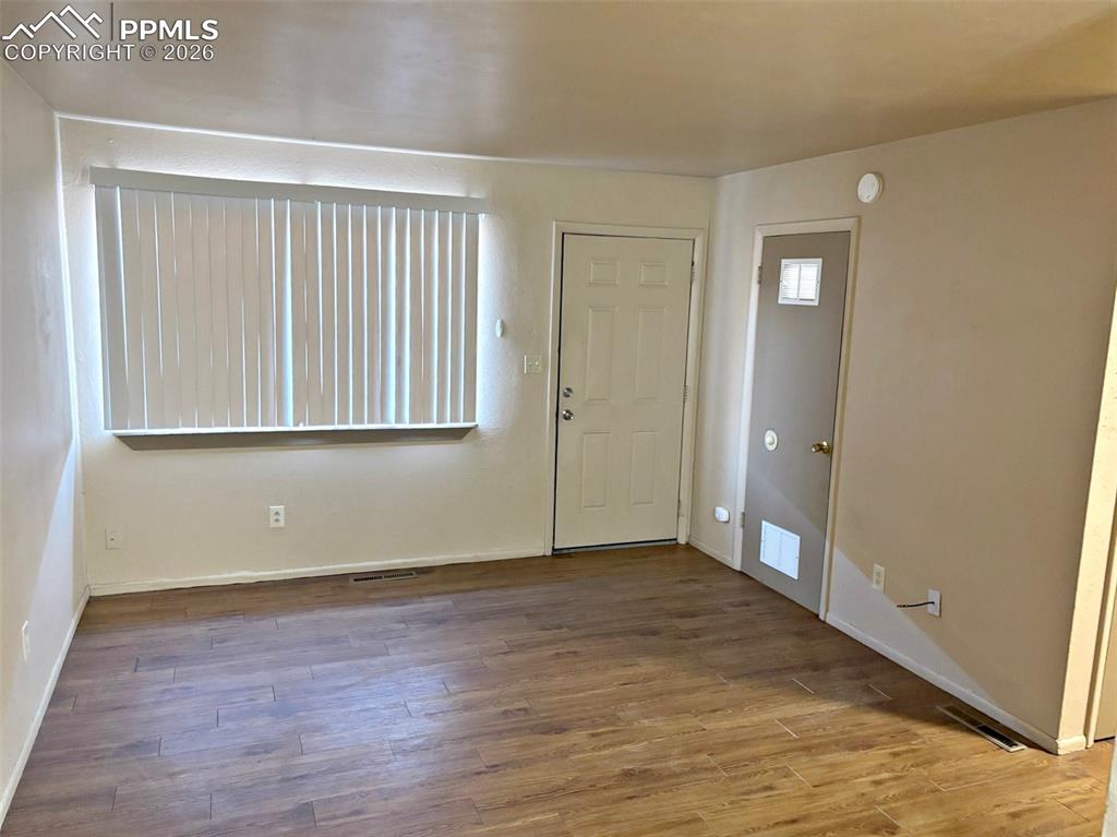 Image 11 of 17: Entrance foyer featuring wood finished floors and baseboards