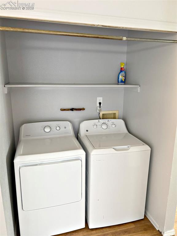Image 15 of 17: Laundry area featuring light wood-type flooring and washer and dryer